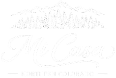 Mi Casa logo with mountains and pine trees