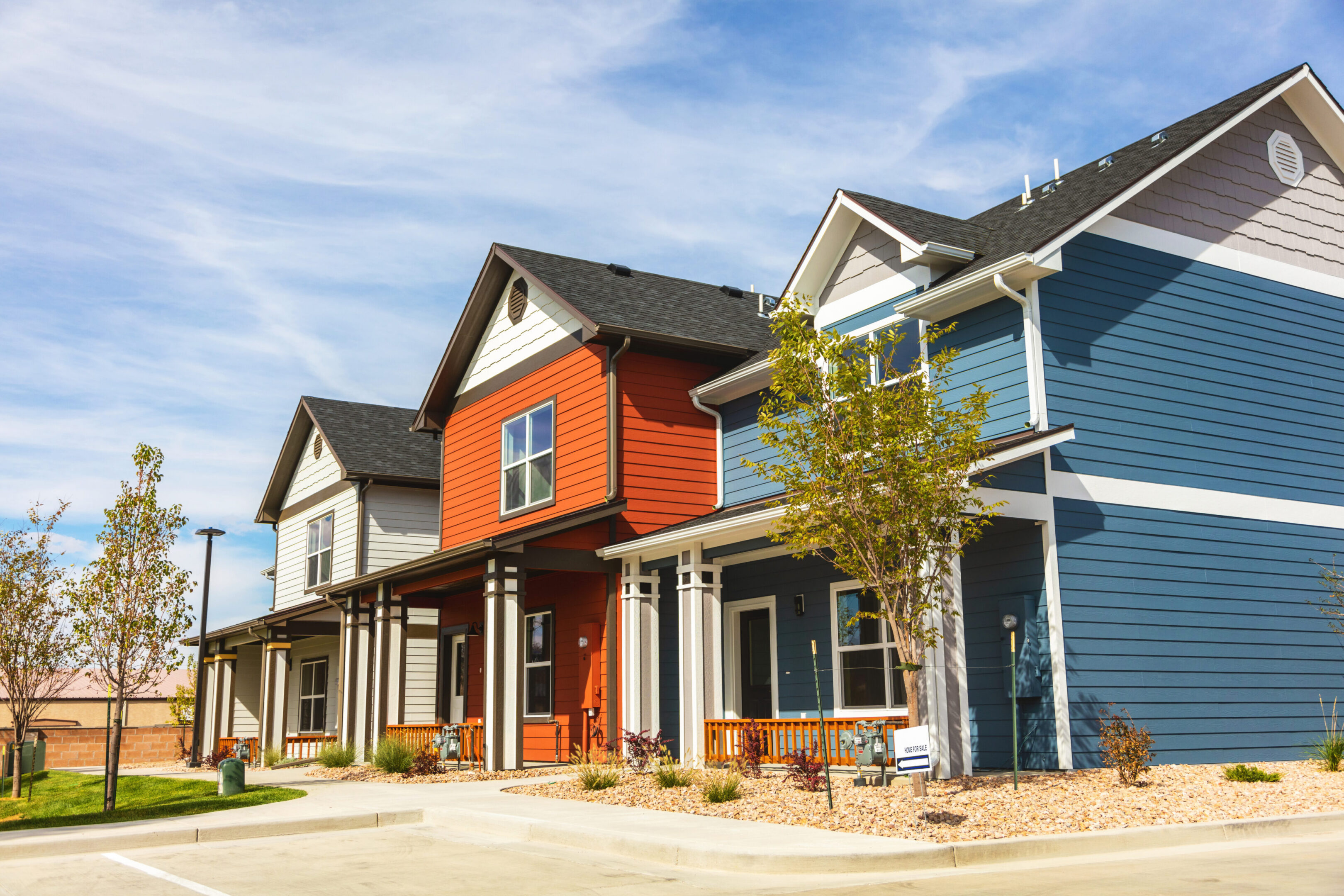Row of colorful suburban townhouses with porches