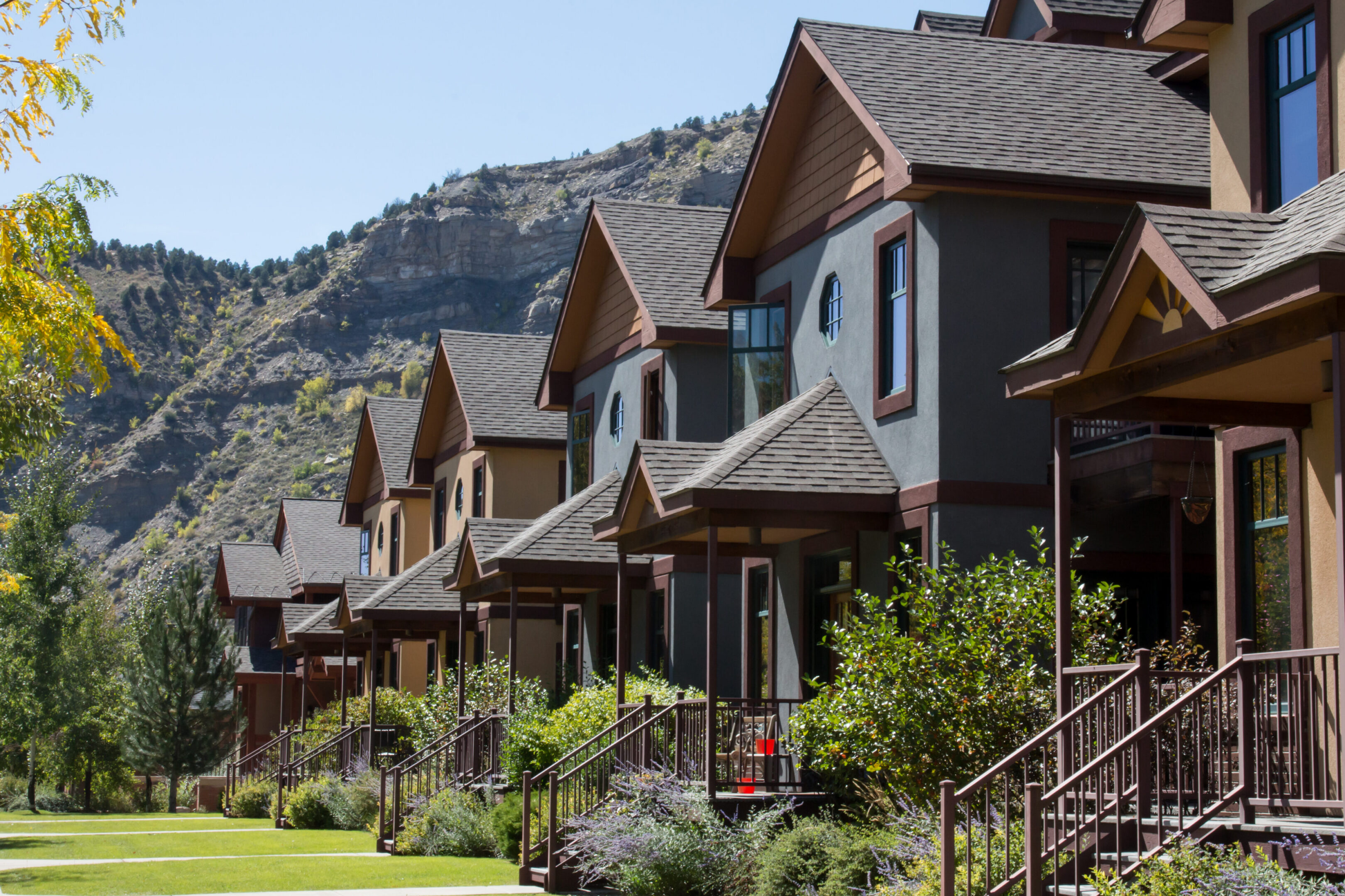 Row of modern townhouses with mountain backdrop