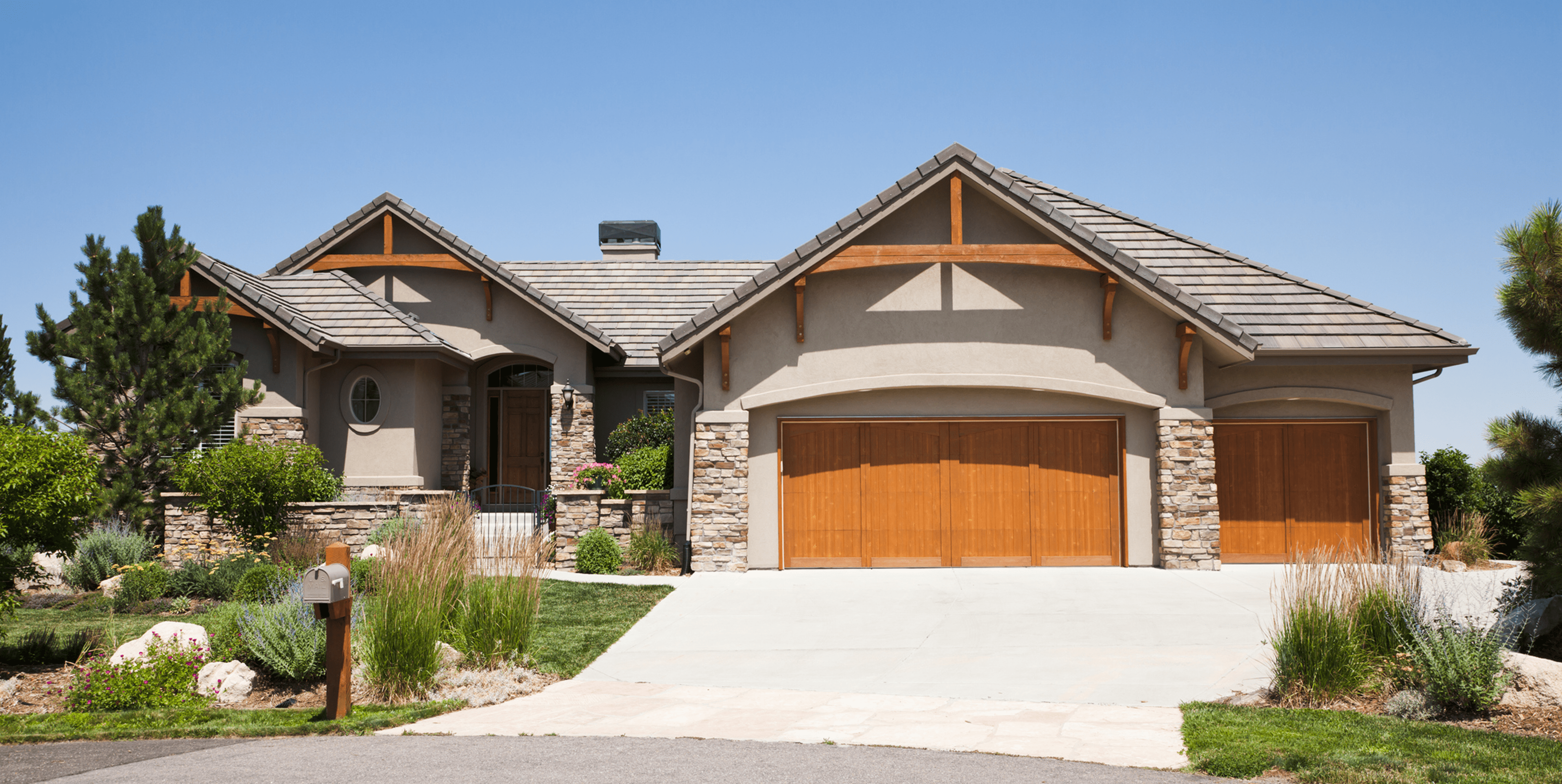 Stone-accented suburban house with wooden garage doors