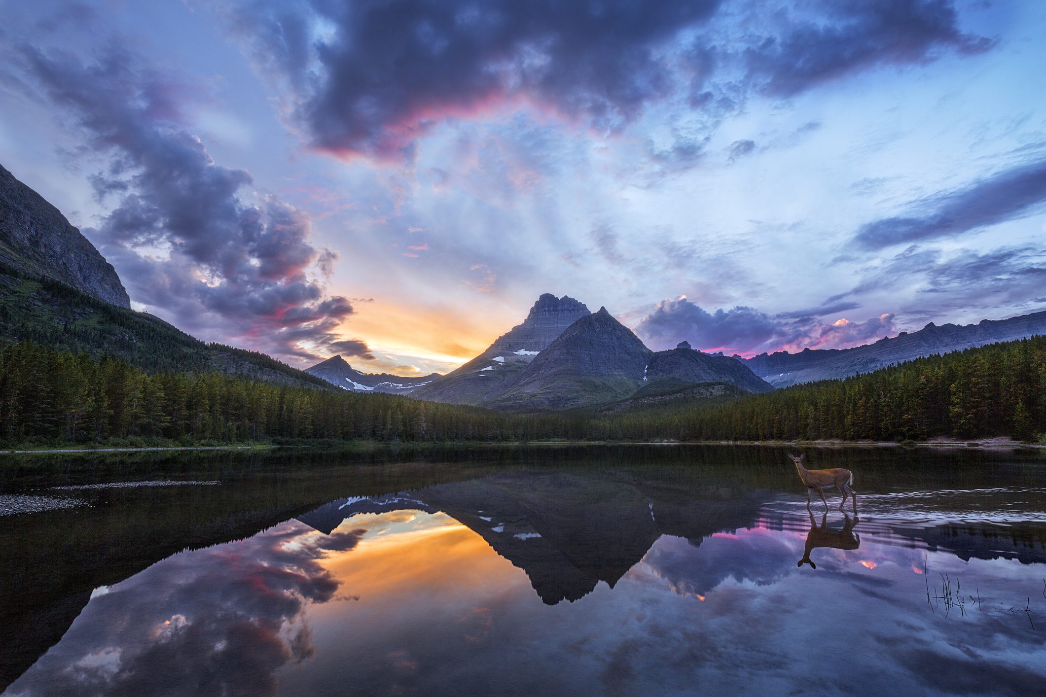 Sunset mountain reflection on calm alpine lake