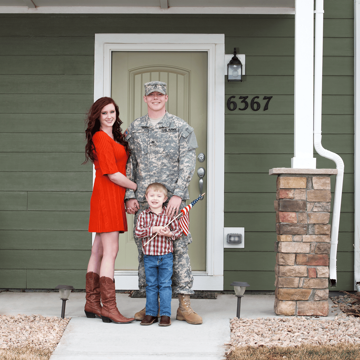 Soldier with family holding American flag