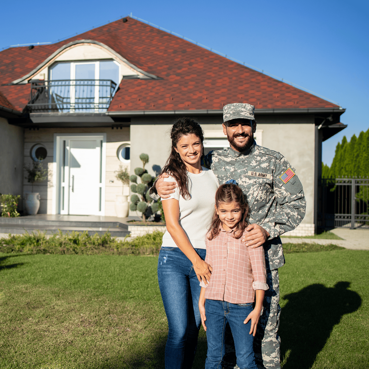 Soldier with family outside suburban house